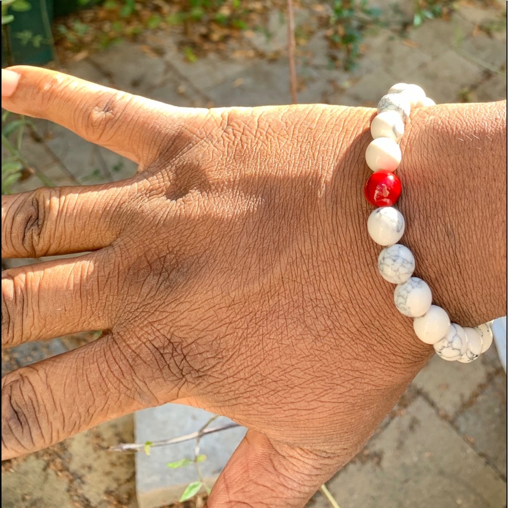 Men’s glossy white marble beads w/one red bead